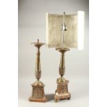 A LARGE PAIR OF METAL PRICKET CANDLESTICKS, converted to lamps. 66cms high.