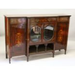 AN EDWARDIAN ROSEWOOD INLAID BREAKFRONT CUPBOARD, the centre with two oval mirrored doors with shelf