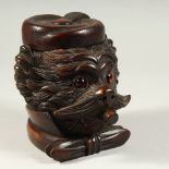 A CARVED WOOD "BLACK FOREST" DOG'S HEAD TEA CADDY. 16cms high.