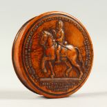 A LOUIS XIII CARVED WOOD CIRCULAR SNUFF BOX, with portrait lid. 8.5cms diameter.