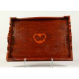 AN ART DECO MAHOGANY INLAID TEA TRAY, inlaid with a butterfly. 52cms long.