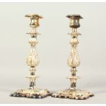 A GOOD PAIR OF PLATED CANDLESTICKS, on square bases. 30cms high.