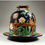 A MAJOLICA STYLE CHEESE DISH AND COVER. 29cms high.