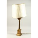 A BRASS CORINTHIAN COLUMN CANDLESTICK, as a lamp with a shade. 52cms high.