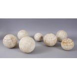 SEVEN VARIOUS INDIAN 19TH AND 20TH CENTURY POLISHED BONE BALLS. 10cms and 12cms diameter.