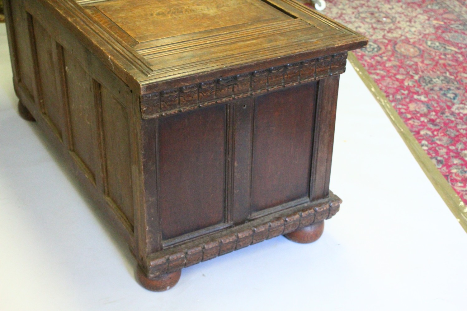 A LARGE 17TH-18TH CENTURY FRENCH OAK COFFER, with two plain panels to the top and two carved - Image 9 of 13