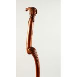 A SLENDER CARVED WOOD WALKING STICK PIXIE. 92cms long.