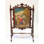 A VICTORIAN MAHOGANY FIRE SCREEN with Berlin tapestry, on curving legs. 116cms high x 74cms wide.