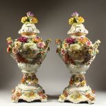 A PAIR OF MEISSEN STYLE VASES, COVERS AND STANDS, with floral encrusted decoration. 72cms high.