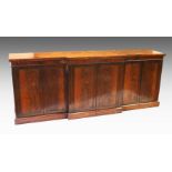 A GOOD REGENCY ROSEWOOD BREAKFRONT STANDING BOOKCASE, the front with three pairs of double doors,