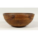 A WOODEN CIRCULAR BOWL. 32cms diameter.