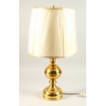 A BRASS TABLE LAMP AND SHADE. 37cms high.