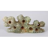 A CARVED GREEN JADEITE SCHOLARS ROCK. 20cms long.