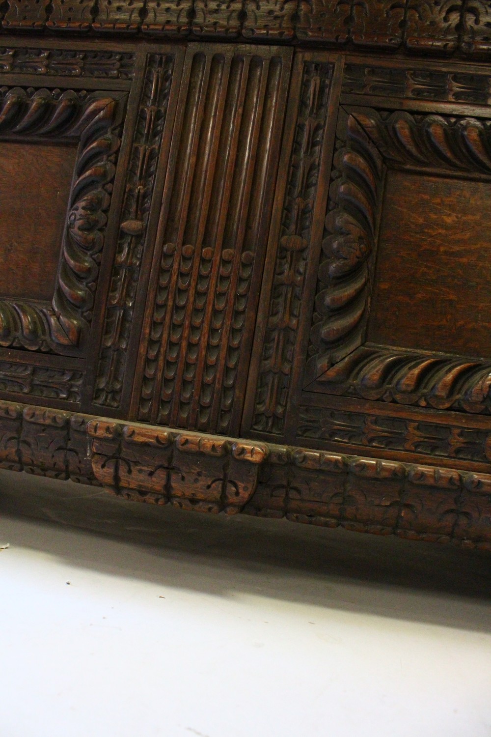 A LARGE 17TH-18TH CENTURY FRENCH OAK COFFER, with two plain panels to the top and two carved - Image 6 of 13