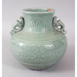 A MING STYLE CELADON TWO-HANDLED VASE, with mounted panels. 20cms high.