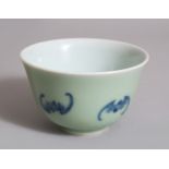 A CELADON PORCELAIN TEA BOWL, decorated with bats. 9cms.