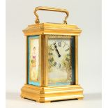 A MINIATURE BRASS CARRIAGE CLOCK, with Sevres style porcelain panels. 9cms high.
