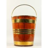 A DUTCH BRASS BOUND WOODEN BUCKET, with brass liner. 34cms high.