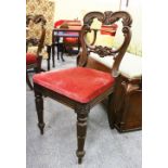 A SET OF FOUR 19TH CENTURY MAHOGANY DINING CHAIRS with carved backs and legs.