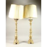 A LARGE PAIR OF ITALIAN CARVED WOOD AND GILDED PRICKET CANDLESTICKS, converted to lamps (with