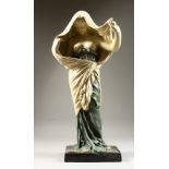 AN ART NOUVEAU STYLE PAINTED POTTERY FIGURE OF A FEMALE STANDING SEMI NUDE. 64cms high.
