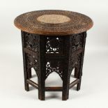 A CARVED AND INLAID CIRCULAR TOP KASHMIR TABLE. 45cms diameter x 45cms high.