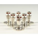 A SET OF SIX SMALL SILVER OWL MENU HOLDERS.