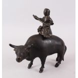 A 19TH / 20TH CENTURY CHINESE BRONZE / CENSOR OF A BOY RIDING A BUFFALO, the boy playing a musical