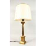 A CORINTHIAN COLUMN BRASS CANDLESTICK, converted to a lamp with a shade.