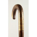 A VERY GOOD WALKING STICK with gold inlaid handle. 98cms long.