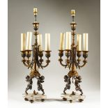 A VERY GOOD PAIR OF 19TH CENTURY FRENCH BRONZE FOUR LIGHT CANDELABRA, with cupid supports, on