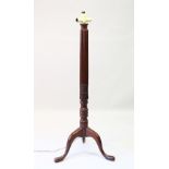 A MAHOGANY STANDARD LAMP with turned column on tripod base. 162cms high.