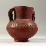 AN EARLY TURKISH POTTERY TWO-HANDLED VASE with pierced top, possibly a strainer 17cms high.