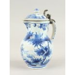 A SMALL DELFT BLUE AND WHITE LIDDED JUG. 14cms high.