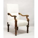 A GOOD ITALIAN OAK FRAMED ARMCHAIR, with padded back and seat, curving arms, on tapering legs.