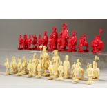 A EUROPEAN AND CHINESE CARVED AND RED STAINED CHESS SET.