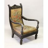 A RARE 19TH CENTURY ANGLO INDIAN CARVED ARMCHAIR with padded back and seat.