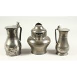 AN 18TH CENTURY PEWTER LIDDED JUG and TWO TAPPIT HENS (3). 17cms, 18cms and 19cms high.