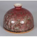 A CHINESE PEACH BLOOM PORCELAIN BEEHIVE WATER POT, the red streaked glaze with green inclusions,