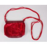 A SMALL PRADA RED EVENING BAG, with long handle, in outer case.