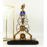 A GOOD MODERN SKELETON CLOCK, with eagle finial, in a glass case. 54cms high.