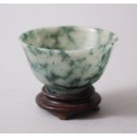 A 19TH / 20TH CENTURY CHINESE JADE TEA BOWL & STAND, 5.4cm diameter x 3.2cm high.