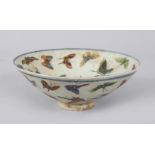 A SMALL CONICAL SHAPED BOWL, decorated with butterflies. 17cms diameter.