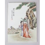 AN EARLY 20TH CENTURY CHINESE PORCELAIN PANEL, painted with figures and calligraphy. 35cms x 26cms.