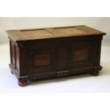 A LARGE 17TH-18TH CENTURY FRENCH OAK COFFER, with two plain panels to the top and two carved