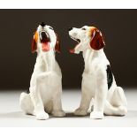 A PAIR OF ROYAL DOULTON PORCELAIN SEATED DOGS YAWNING, HN1099.