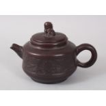 A CHINESE YIXING TERRACOTTA POTTERY TEAPOT AND COVER, with kylin handle.