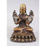 A BRONZE SEATED DEITY, inset with hardstones. 19cms high.