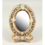 A 19TH CENTURY VENETIAN OVAL EASEL MIRROR, with enamel mosaic flowers. 32cms high.