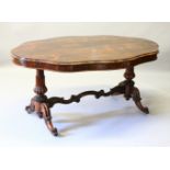 A LARGE LATE REGENCY ROSEWOOD OVAL SHAPED TOP LIBRARY TABLE, on good carved end supports and curving